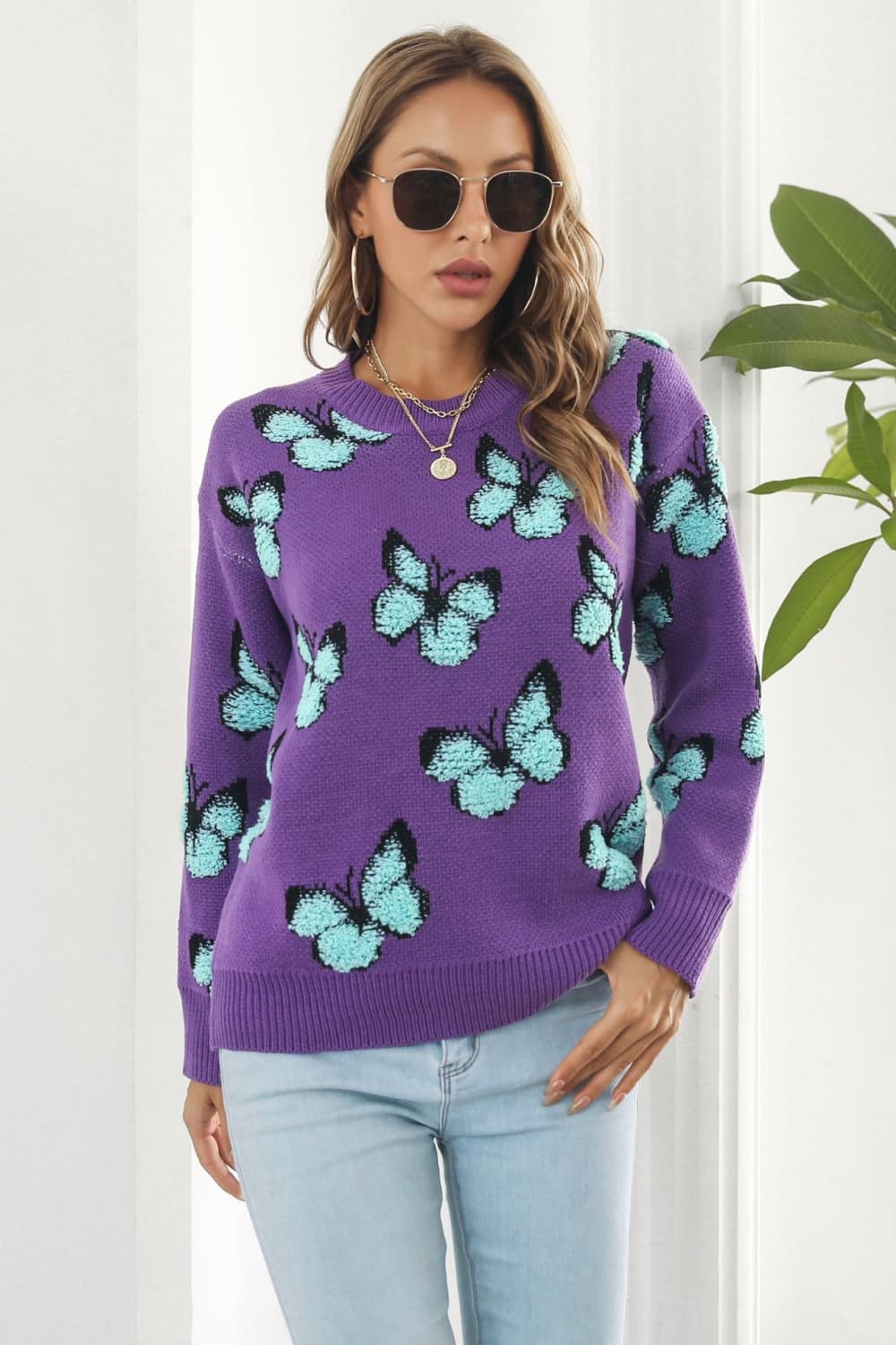 Purple knit crewneck pullover sweater with allover light blue butterfly motif