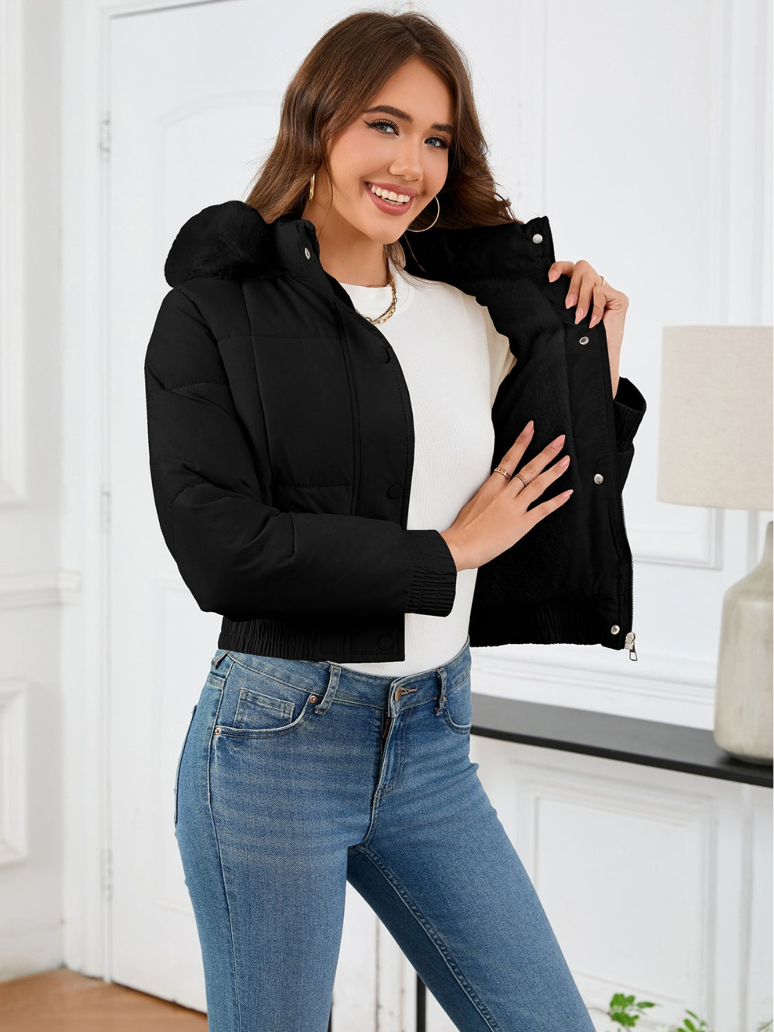 Black puffer jacket with faux fur trim on hood and collar, cropped length.