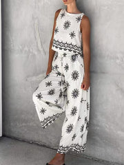 White two-piece set with medallion print, sleeveless top and wide-leg drawstring pants.