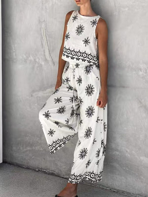 White two-piece set with medallion print, sleeveless top and wide-leg drawstring pants.