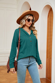 Green textured henley hoodie with drop shoulder and button detail