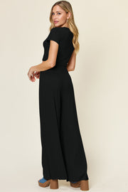 Black cropped tee and wide-leg palazzo pants set from the back.