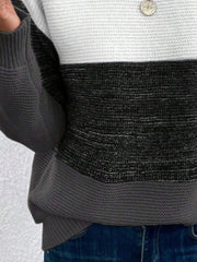 Colorblock ribbed knit sweater with white, black, and gray stripes.