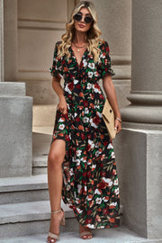 Black tiered floral maxi dress with puff sleeves and a high slit.