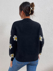 Black knit sweater with puff sleeves and white daisy pattern