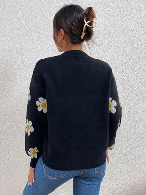 Black knit sweater with puff sleeves and white daisy pattern