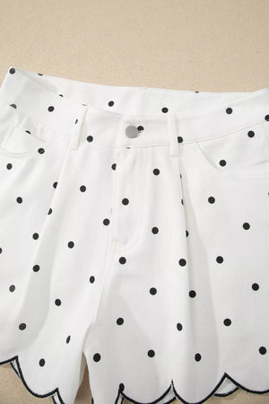 White chino shorts with black polka dots and scalloped hem detail.