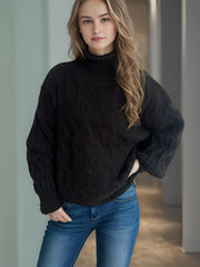 Black oversized cable knit turtleneck sweater with acrylic blend.