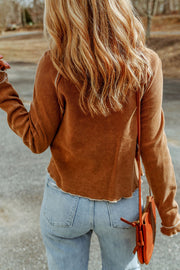Caramel waffle knit raglan sweater with ruffled cuffs and raw hem detail.