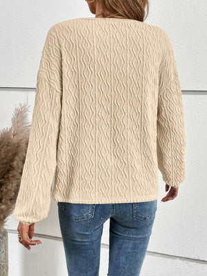 Textured ivory blouson sleeve henley top with button detail.