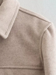 Beige trucker jacket with collared neckline and visible stitching detail.