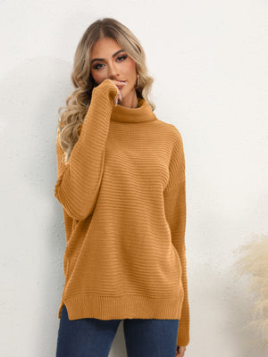 Textured knit oversized turtleneck pullover in mustard acrylic with ribbed details and side slits.