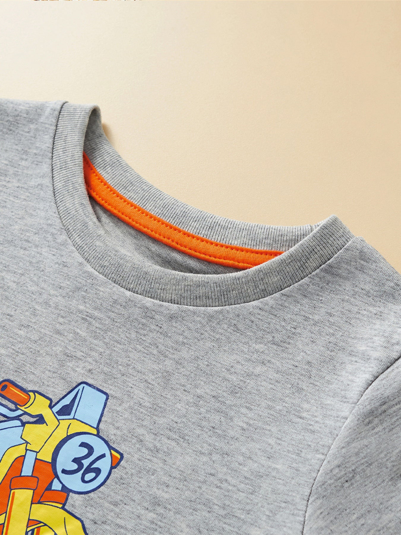 Toddler grey cotton graphic t-shirt with orange trim and motorcycle print.