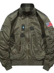 Army green bomber jacket with multiple zippered pockets, patches, and American flag detail.
