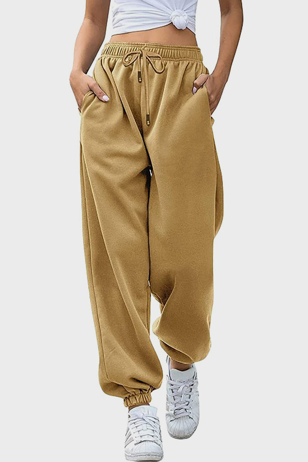 Slouchy sweatpants in tan with gathered cuffs and drawstring waist.