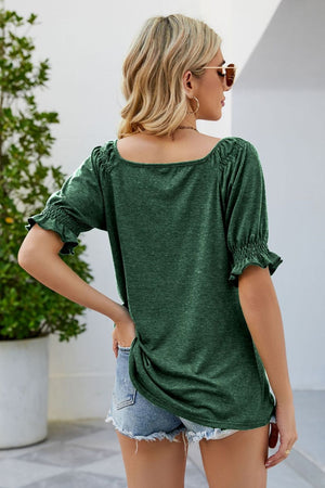 Gathered square neck blouse in Gum Leaf green with puff sleeves and ruffled cuffs.