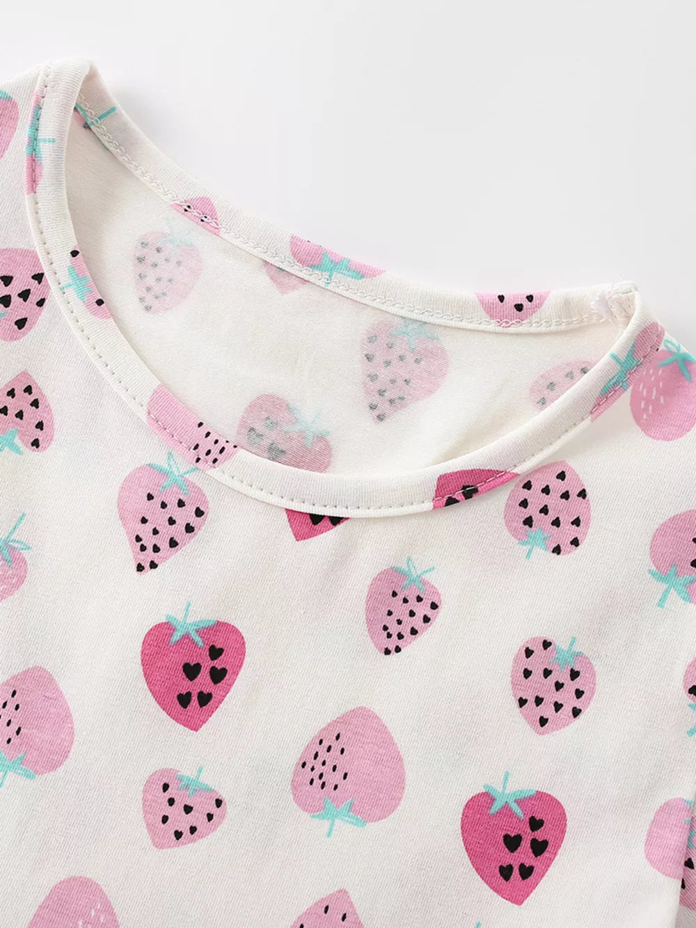 Toddler cotton dress with pink strawberry print and ruffled details.
