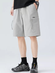 Light gray men's cargo shorts with zip pockets and drawstring waist.