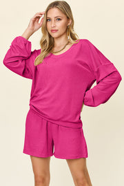 Hot pink waffle knit lounge set with blouson sleeves and shorts.