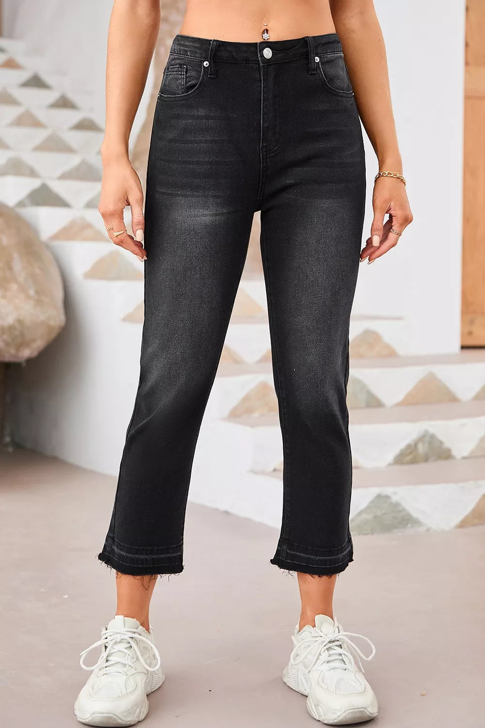 Maternity jeans in charcoal wash denim with distressed raw hem and cropped length.
