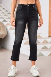 Maternity jeans in charcoal wash denim with distressed raw hem and cropped length.