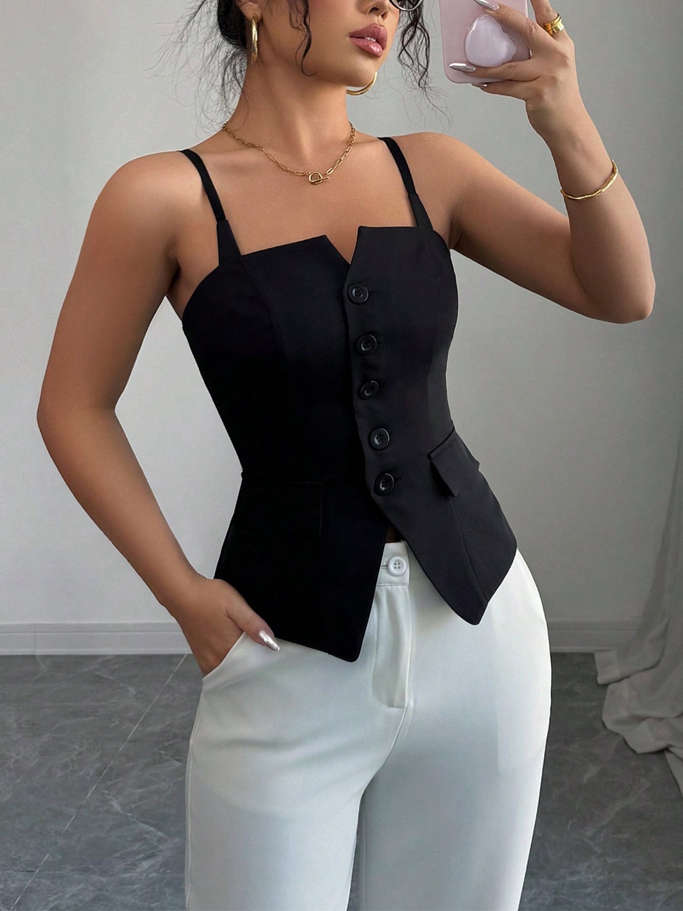 Black V-cut button-front cami top with adjustable straps and pocket details.