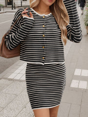 Black and white striped knit co-ord set with buttoned cardigan and fitted skirt.