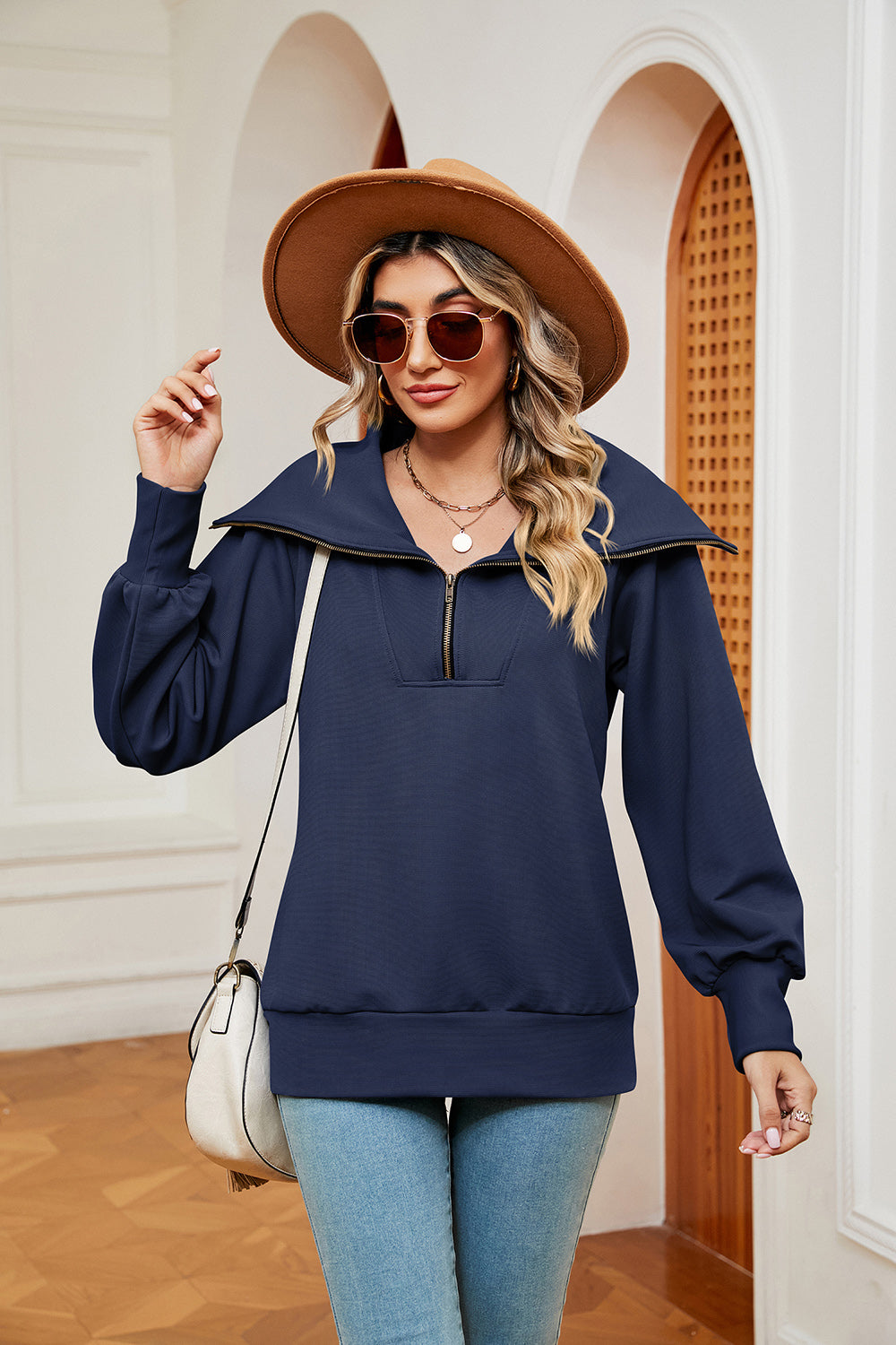 Navy blue zip-through sweatshirt with wide collar and balloon sleeves.