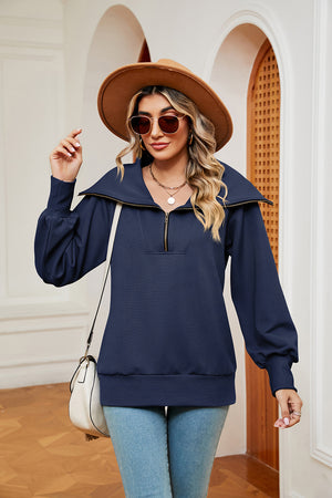 Navy blue zip-through sweatshirt with wide collar and balloon sleeves.