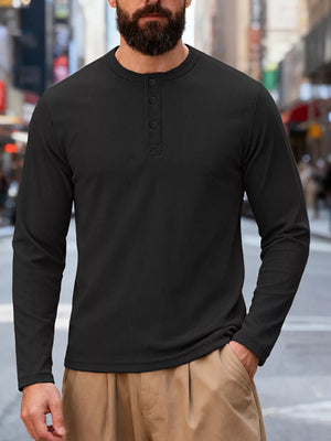 Men's black long sleeve cotton henley t-shirt with button placket.
