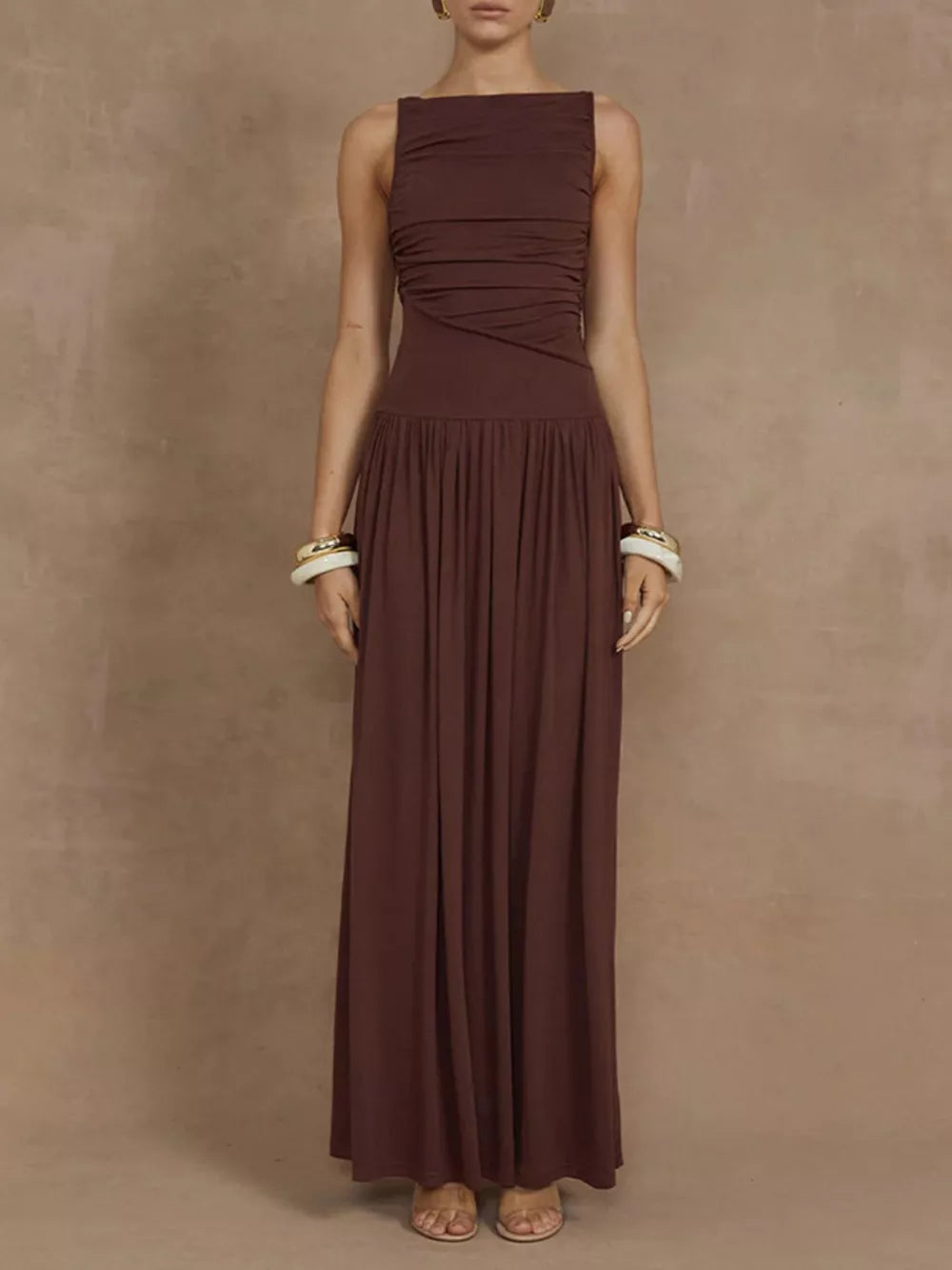 Brown ruched maxi dress with a square neckline and flowing skirt.