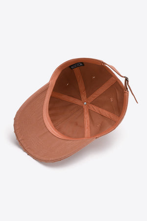 Coral baseball cap with distressed brim and adjustable strap, showing interior.