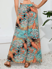 Tropical print palazzo trousers with a slit leg in multicolor.