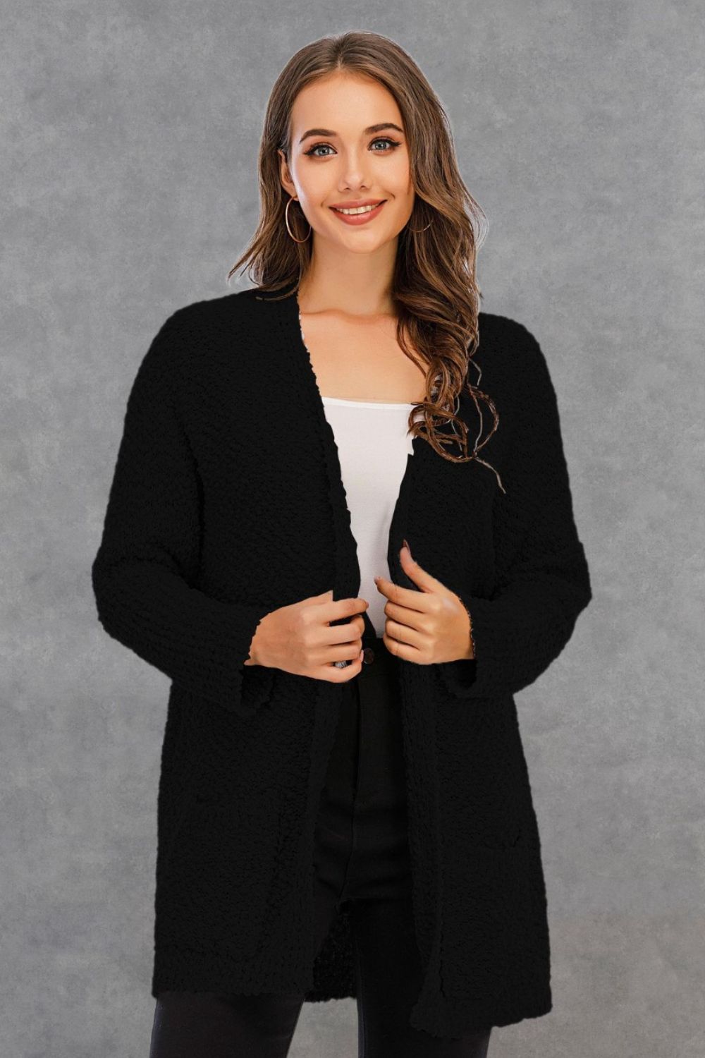 Black textured cocoon cardigan with patch pockets and open front.