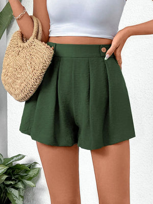 Dark green high-waisted pleated shorts with button detail