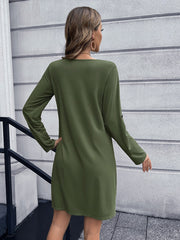 Olive green button-down mini dress with long sleeves and A-line cut.