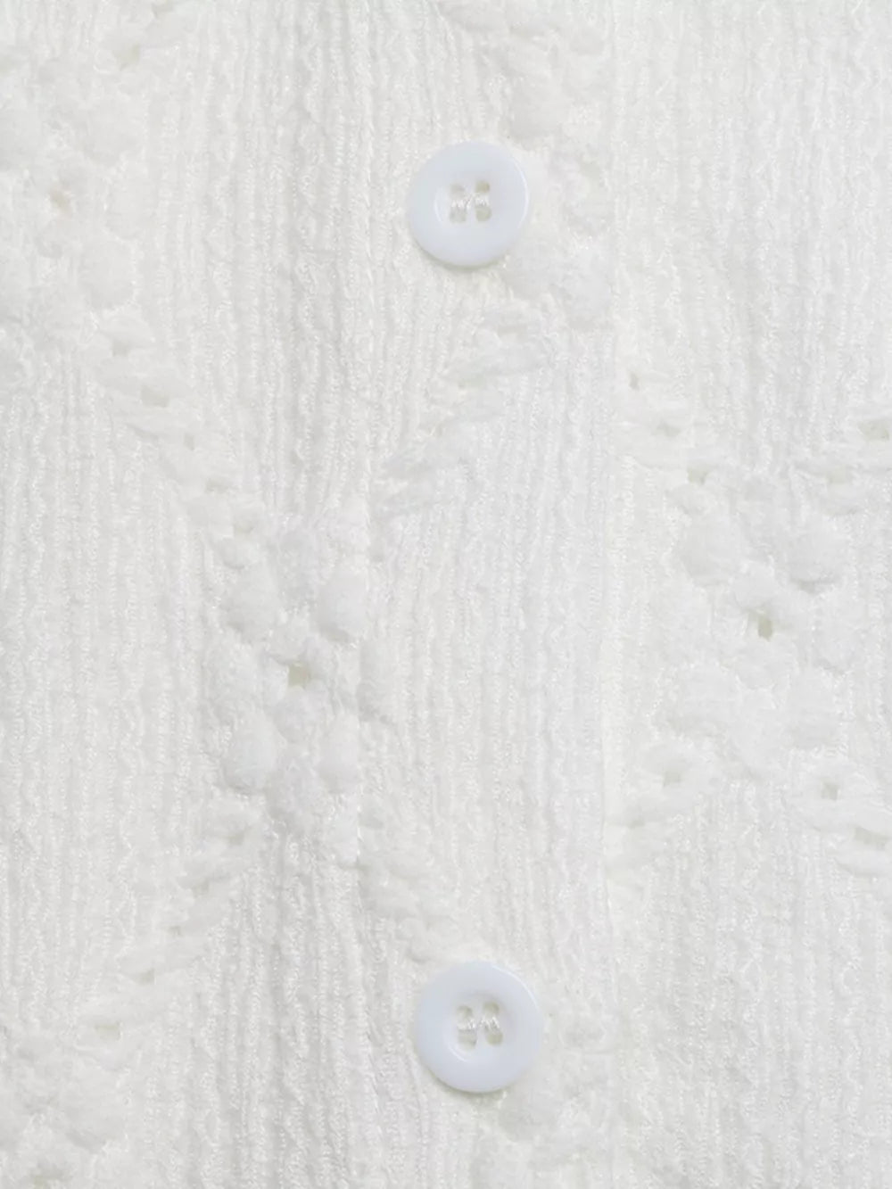 White lace-trimmed button-up maternity shirt with textured fabric and ruffle sleeves.