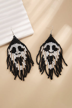 Beaded skull fringe earrings in black and white with dangling strands.