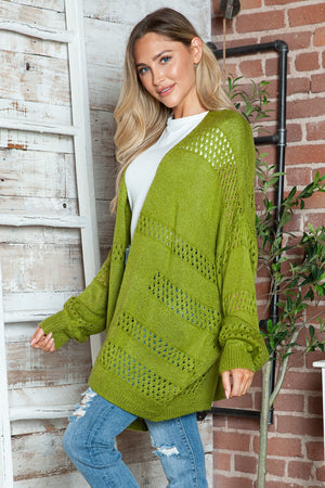 Open-knit slouchy cardigan in matcha green with diagonal openwork details and long sleeves.