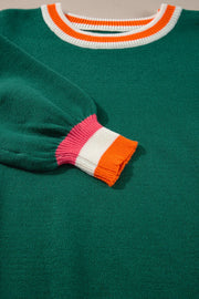 Dark green knit sweater with balloon sleeves and colorblock trim on neckline and cuffs.