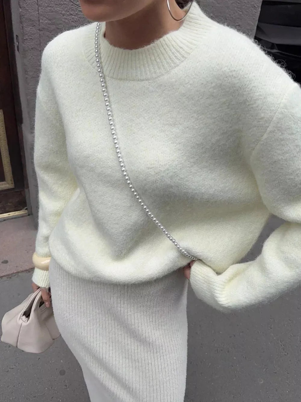 Cozy knit top in beige with relaxed fit and crewneck.