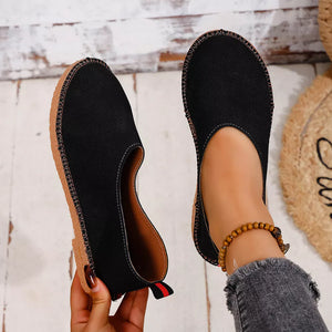 Black espadrille-inspired round toe slip-on flats with contrast stitching and a pull tab.