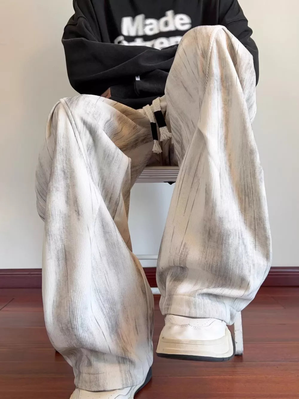 Off-white vintage wash utility cargo pants with drawstring detail and vertical stripe pattern