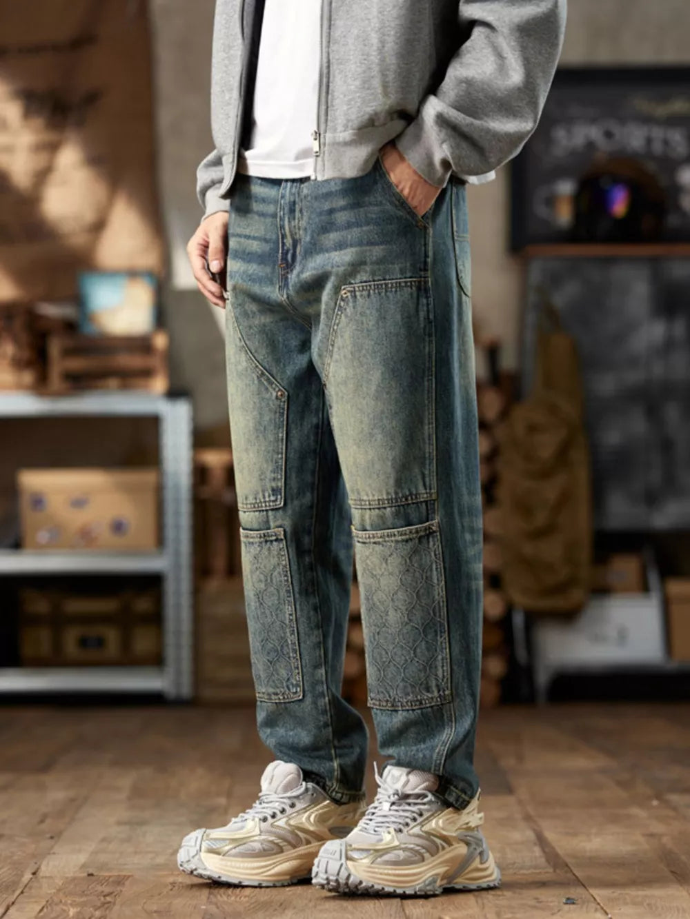 Men's blue cotton straight leg jeans with patchwork details and a vintage wash.