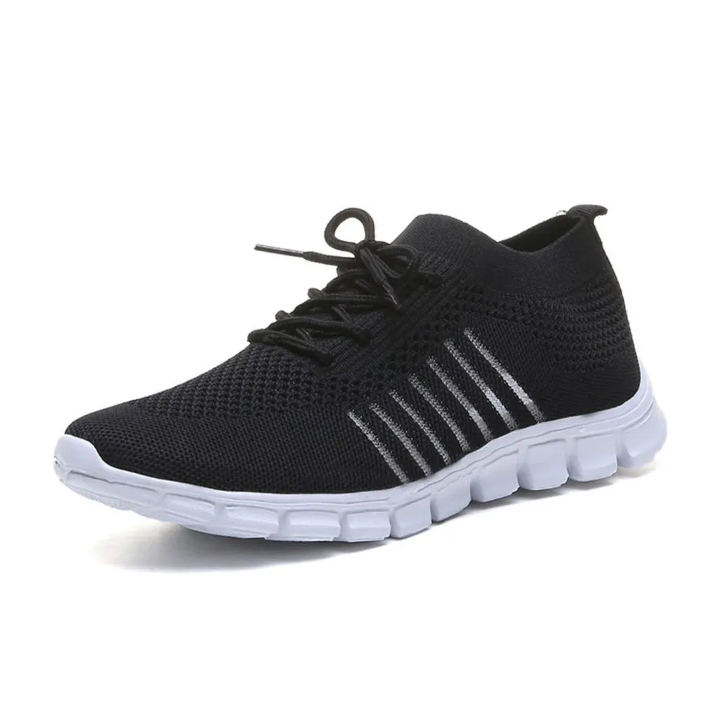 Black knit runner sneakers with ribbed detail and white sole.