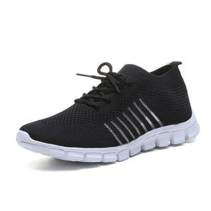 Black knit runner sneakers with ribbed detail and white sole.