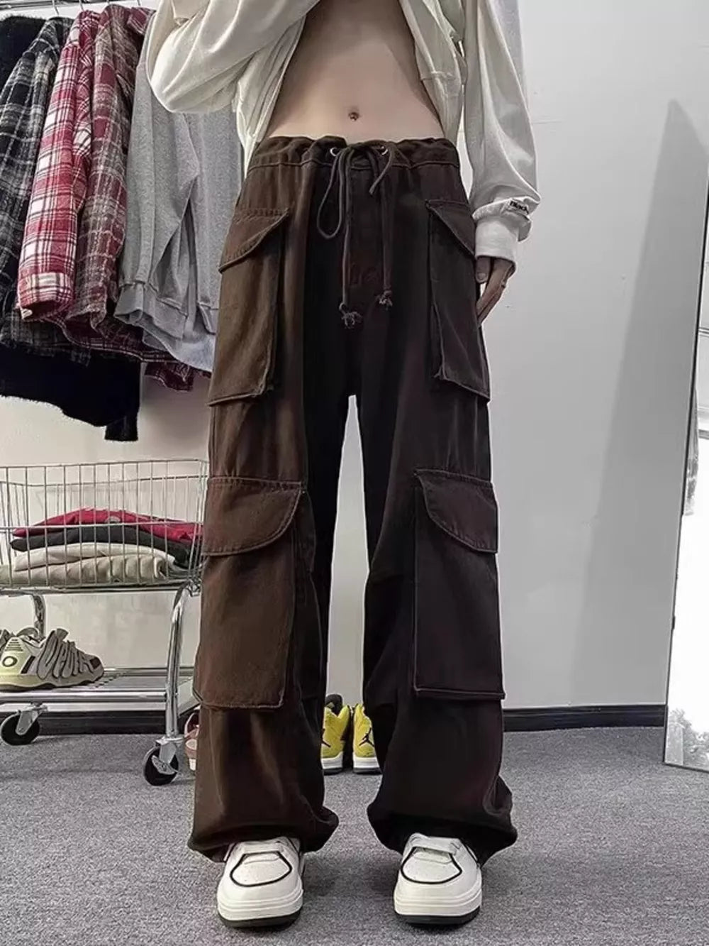 Brown cargo pants with multiple large pockets and a drawstring waist.