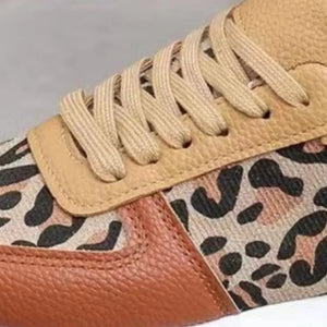 Leopard print panel runner sneakers with tan laces and brown leather accents.