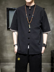 Black cotton blend short sleeve shirt with mandarin collar and decorative buttons.
