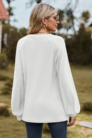 White waffle knit raglan sweater with laser cut detail on sleeves